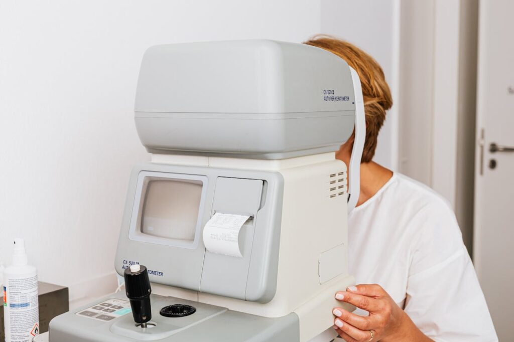 Close-up view of an optometrist using an autorefractor for an eye examination in a clinical setting.
